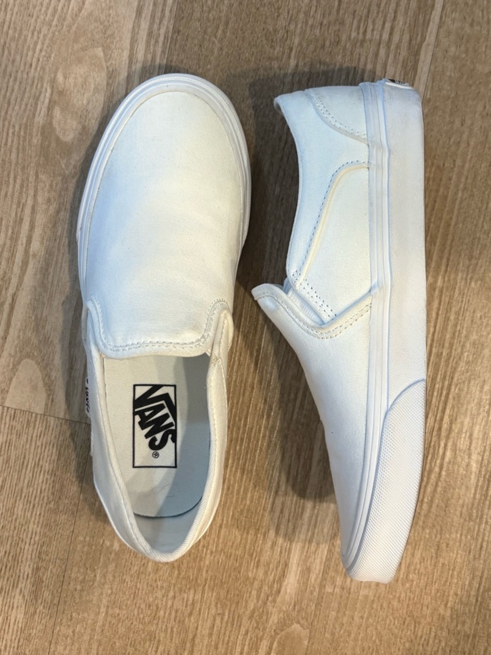 All white monochrome Slip-On vans